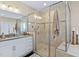Luxurious bathroom featuring a glass-enclosed shower with multiple shower heads at 437 Creekhurst Pl, Cary, NC 27519