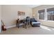 Cozy bedroom featuring a comfortable chair, large window with blinds and hardwood desk at 437 Creekhurst Pl, Cary, NC 27519