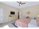 Bedroom featuring a cream dresser, a mounted television, and a ceiling fan at 437 Creekhurst Pl, Cary, NC 27519