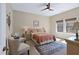 Serene bedroom with neutral tones, a ceiling fan, and two side chairs at 437 Creekhurst Pl, Cary, NC 27519