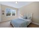 Bedroom featuring a large window, a bed with blue accents, and a bedside table at 437 Creekhurst Pl, Cary, NC 27519