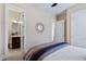 Bedroom with open door to bathroom, decorative mirror, and neutral walls at 437 Creekhurst Pl, Cary, NC 27519