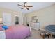 Comfortable bedroom with a ceiling fan, a papasan chair, and a whitewashed dresser at 437 Creekhurst Pl, Cary, NC 27519