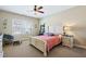 Cozy bedroom featuring a ceiling fan, a papasan chair, and a bedside table at 437 Creekhurst Pl, Cary, NC 27519