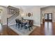 Elegant dining area with staircase, decorative wall art, and stylish seating at 437 Creekhurst Pl, Cary, NC 27519