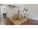 Dining area adjacent to a kitchenette, featuring seating for six and wicker chairs at 437 Creekhurst Pl, Cary, NC 27519