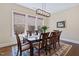 Bright dining room with a large window, wood table, and elegant decor at 437 Creekhurst Pl, Cary, NC 27519