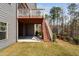 Back exterior view showing deck and stairs leading to the lush green yard at 437 Creekhurst Pl, Cary, NC 27519