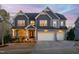 Beautiful two-story home with a three-car garage, eye-catching curb appeal and professionally landscaped yard at 437 Creekhurst Pl, Cary, NC 27519