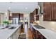 Modern kitchen with stainless steel appliances, white countertops, and wooden cabinets and floors at 437 Creekhurst Pl, Cary, NC 27519