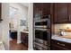 Kitchen boasts stainless steel appliances, dark cabinetry, and seamless flow to the living space at 437 Creekhurst Pl, Cary, NC 27519
