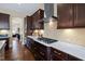 Modern kitchen with stainless steel appliances, white countertops, mosaic backsplash, and dark cabinets at 437 Creekhurst Pl, Cary, NC 27519