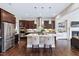 Modern kitchen features stainless steel appliances, large island, dark cabinets, and hardwood floors at 437 Creekhurst Pl, Cary, NC 27519