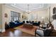 Elegant living room showcasing blue sofas, wood floors, and a coffered ceiling at 437 Creekhurst Pl, Cary, NC 27519