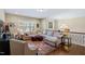 Comfortable living room with a large sectional sofa, hardwood floors, and natural lighting at 437 Creekhurst Pl, Cary, NC 27519