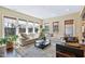 Sunlit living room with hardwood floors, large windows, and comfortable seating at 437 Creekhurst Pl, Cary, NC 27519