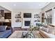 Cozy living room features a fireplace, built-in bookshelves, hardwood floors, and neutral decor at 437 Creekhurst Pl, Cary, NC 27519