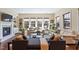 Bright living room with large windows, hardwood floors, fireplace, and neutral decor at 437 Creekhurst Pl, Cary, NC 27519