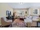 Spacious upstairs living area featuring a comfortable sectional, ottomans, and a decorative rug at 437 Creekhurst Pl, Cary, NC 27519