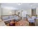 Open living area with plush sofa, stylish rug, and cozy seating arrangement at 437 Creekhurst Pl, Cary, NC 27519