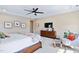 Spacious main bedroom with tray ceilings, ceiling fan, and a seating area at 437 Creekhurst Pl, Cary, NC 27519