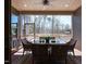Covered outdoor patio with dining table, wicker chairs, and screened views of the backyard at 437 Creekhurst Pl, Cary, NC 27519