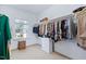 Spacious walk-in closet with window, shelving, and hanging space for storage at 437 Creekhurst Pl, Cary, NC 27519