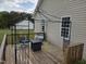 Relax on this spacious back deck complete with outdoor seating and a cozy fire pit at 46 Grain Ln, Henderson, NC 27537