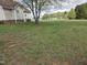 Large backyard with mature trees offering privacy at 46 Grain Ln, Henderson, NC 27537