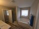 Bright bathroom featuring a tub, a separate shower and neutral decor at 46 Grain Ln, Henderson, NC 27537