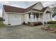Charming home with attached garage, manicured lawn, and inviting front porch at 46 Grain Ln, Henderson, NC 27537