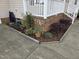 Landscaping and potted plants add to the charm of the front porch of this home at 46 Grain Ln, Henderson, NC 27537