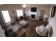 Inviting living room with a fireplace, ceiling fan, wood flooring, and ample natural light at 46 Grain Ln, Henderson, NC 27537