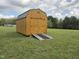 Wooden shed with ramp in backyard for outdoor storage at 46 Grain Ln, Henderson, NC 27537