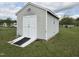Vinyl shed with ramp in backyard provides extra storage at 46 Grain Ln, Henderson, NC 27537