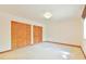 A bedroom has neutral walls and carpet, plus a pair of wood folding doors to closets at 505 Marion Way, Chapel Hill, NC 27516