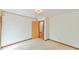 Clean, carpeted bedroom with neutral walls and view into hall at 505 Marion Way, Chapel Hill, NC 27516