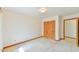 A bedroom has neutral carpet and wood folding doors to a closet at 505 Marion Way, Chapel Hill, NC 27516