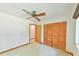 Bedroom features wood trim, neutral carpet, and closet with folding doors at 505 Marion Way, Chapel Hill, NC 27516