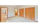 This bedroom features neutral carpet and two closets with folding doors at 505 Marion Way, Chapel Hill, NC 27516