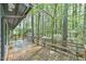 A wooden deck with benches overlooks the wooded backyard and a small shed at 505 Marion Way, Chapel Hill, NC 27516