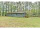 Home exterior view showcasing the side, large lawn, carport and wooded surroundings at 505 Marion Way, Chapel Hill, NC 27516