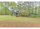 Home with a large lawn, trees, carport and front porch, showcasing a spacious property at 505 Marion Way, Chapel Hill, NC 27516