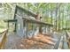 A charming home with a large wooden deck, perfect for entertaining, surrounded by mature trees at 505 Marion Way, Chapel Hill, NC 27516