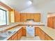 Clean kitchen featuring ample cabinets, tile countertops and flooring, and stainless steel sink at 505 Marion Way, Chapel Hill, NC 27516
