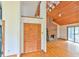 Open-concept living space with wood ceilings, and inviting brick fireplace at 505 Marion Way, Chapel Hill, NC 27516