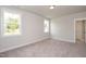 Bright, carpeted bedroom with two windows that provide natural light at 520 Folk Song Way, Wendell, NC 27591