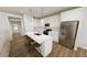 Modern kitchen with white cabinets, stainless steel appliances, and a large island with bar seating at 520 Folk Song Way, Wendell, NC 27591