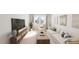 Bright living room with large window, wood console, white sofa and modern decor at 520 Folk Song Way, Wendell, NC 27591