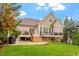 Expansive backyard with a large deck, green lawn, and mature trees, perfect for outdoor living at 528 Clifton Blue St, Wake Forest, NC 27587